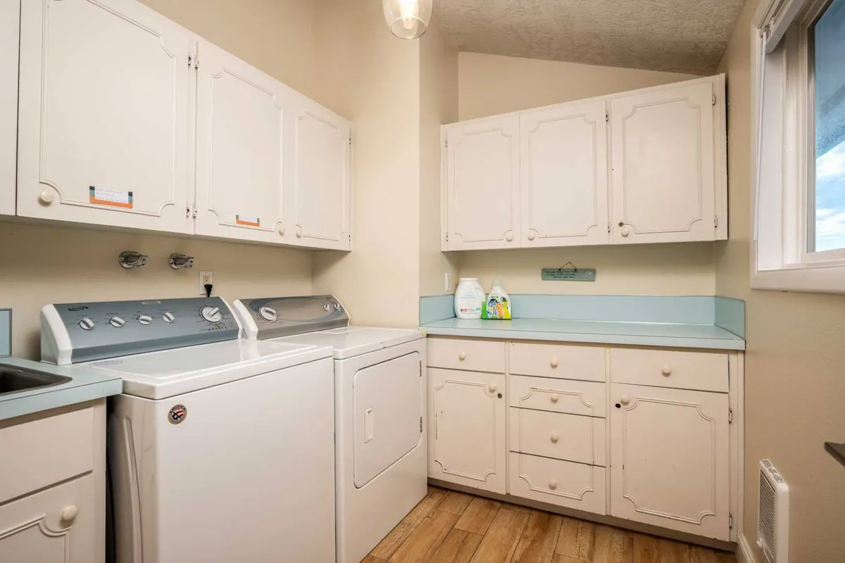 A dedicated laundry space with a washing machine, drying machine, and storage cabinets. The area is organized and practical, emphasizing home-like amenities for easy, everyday living.